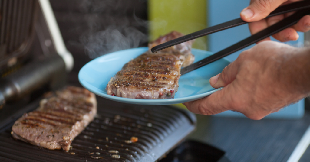 cooking the steak on an electric grill